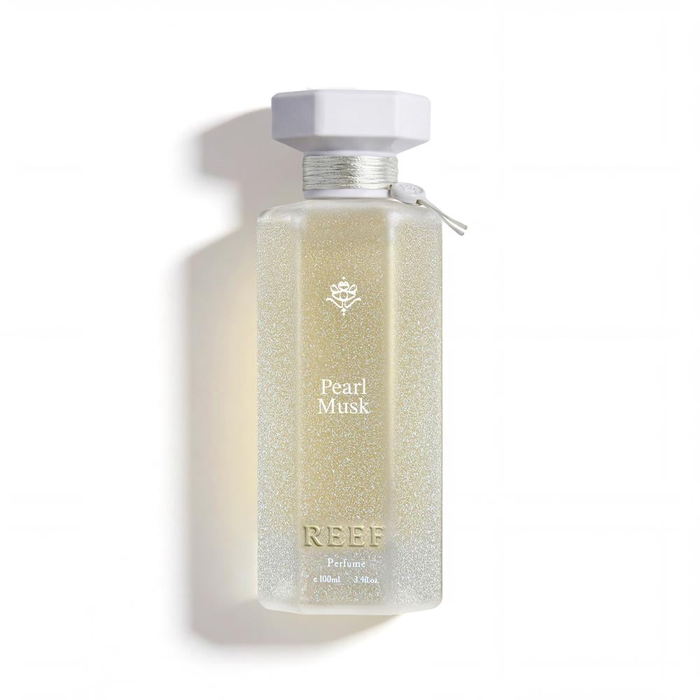 Pearl Musk perfume bottle with glittery gold design and white cap, evoking luxury and elegance
