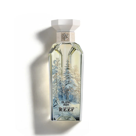 Blanc Ash REEF perfume bottle with snowy forest design, elegant white cap, and luxury fragrance notes