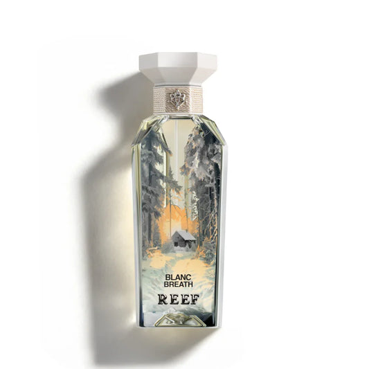 Blanc Breath perfume bottle with snowy forest scene, evoking winter freshness and serene woodland aromas