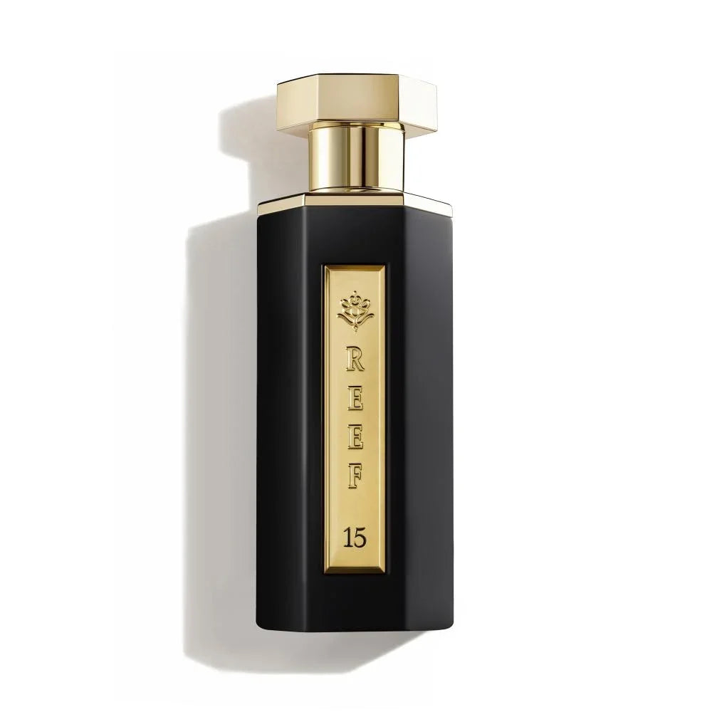 Elegant black perfume bottle with gold accents, labeled REEF 15, evoking luxury and oriental fragrance notes