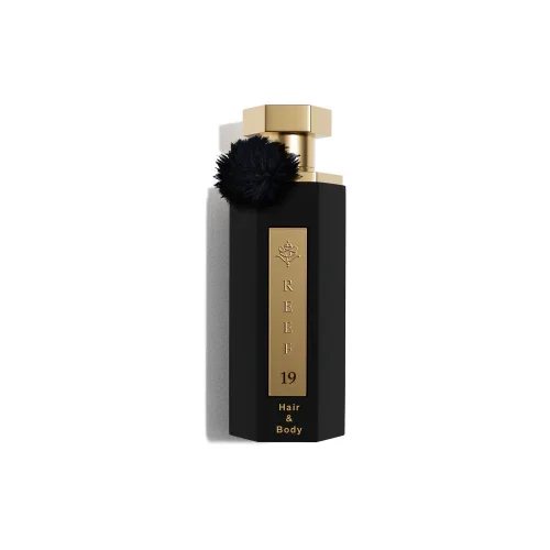 Luxury black perfume bottle with gold cap and black pom-pom, REEF 19 Hair & Body fragrance