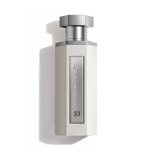 REEF 33 luxury perfume bottle with silver cap and elegant white design