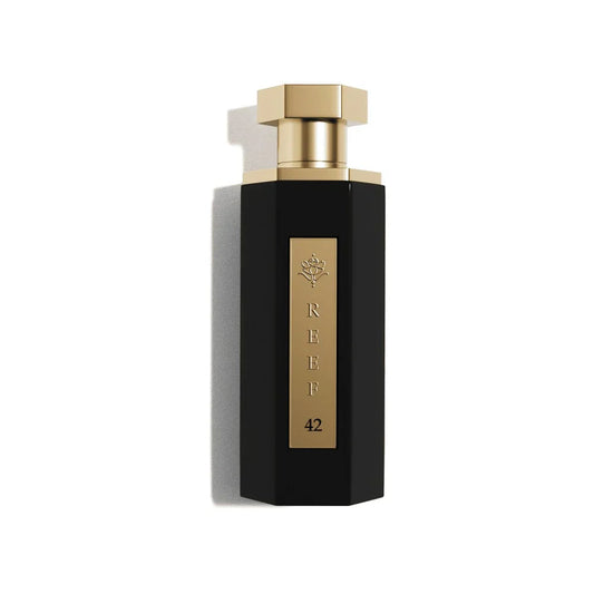 Elegant black perfume bottle with gold accents, labeled REEF 42, evoking luxury and oriental fragrance notes