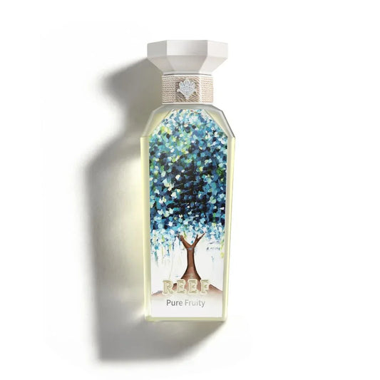 REEF Pure Fruity perfume bottle with artistic tree design and elegant white cap